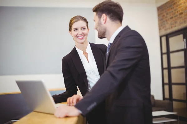 Business people talking by counter