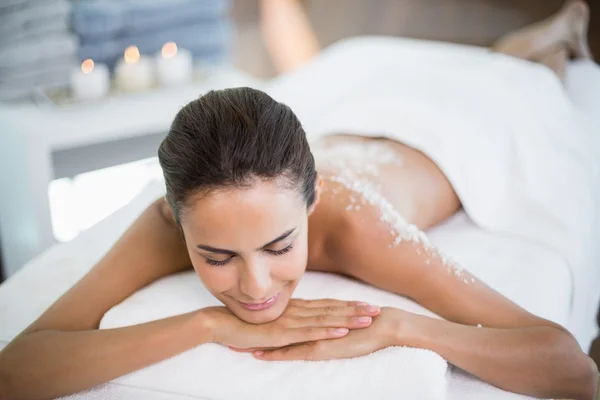 Woman relaxing on massage table at spa