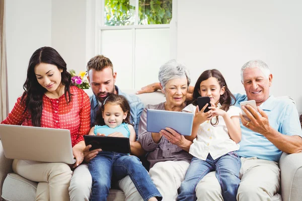 Family using technologies in sofa