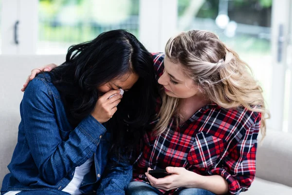 Woman consoling crying female friend