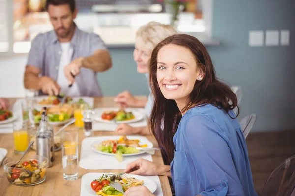 Woman having breakfast with family