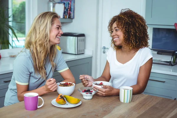 Friends having breakfast at kitchen table