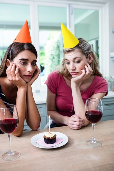 Sad friends during birthday party