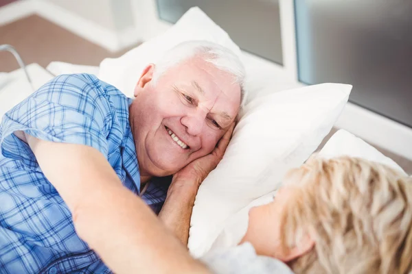 Senior couple lying on bed