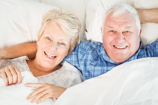 Senior couple lying on bed