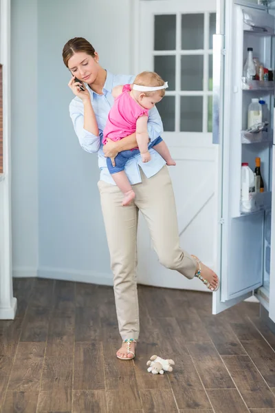 Woman closing refrigerator door