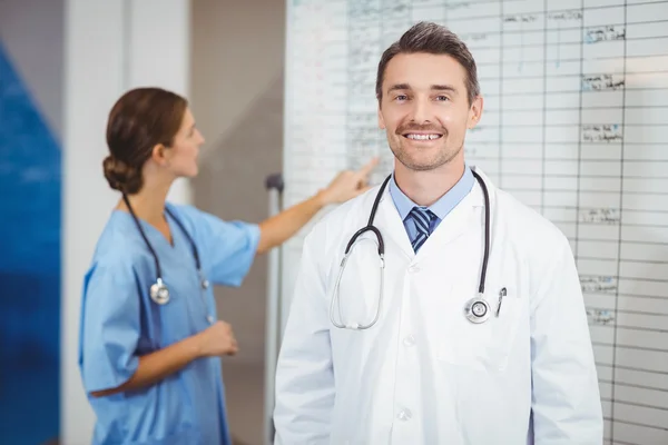 Doctor with colleague pointing at chart