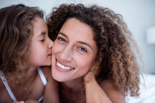 Daughter kissing mother on cheek