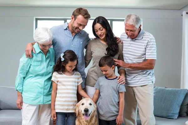 Family standing together with dog