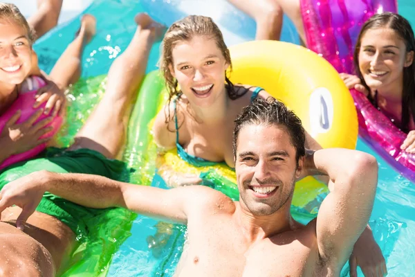 Happy friends enjoying in the swimming pool