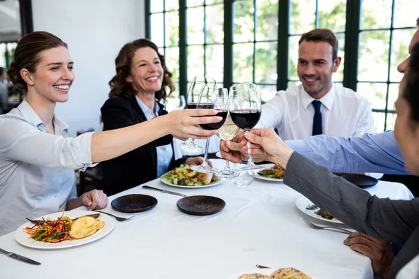 Businesspeople toasting wine glasses