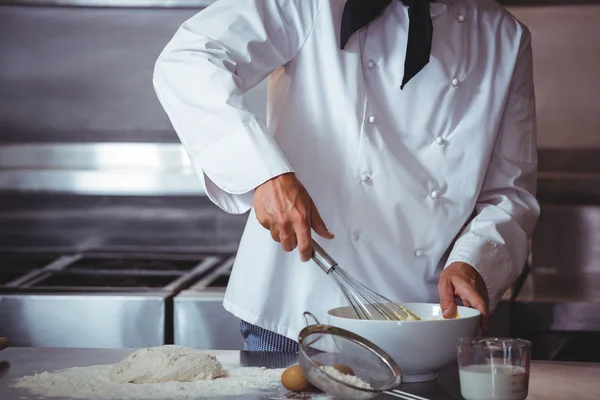 Focused chef preparing a cake