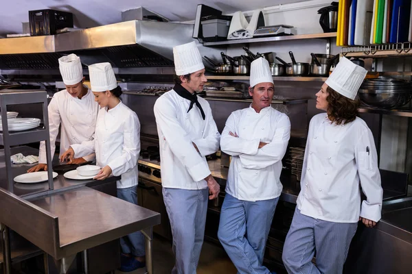 Chefs standing in commercial kitchen