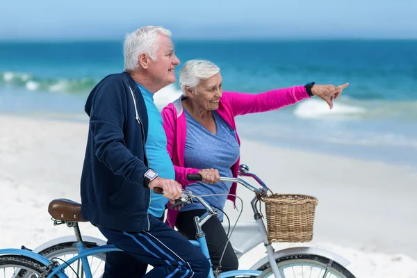 Mature couple riding bicycles