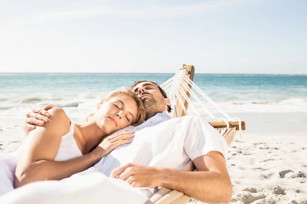 Couple sleeping in hammock