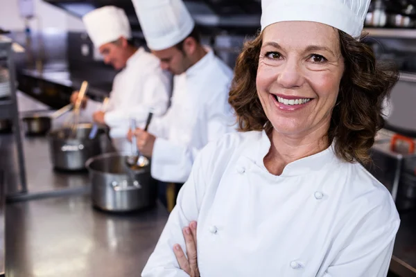 Smiling chef in commercial kitchen