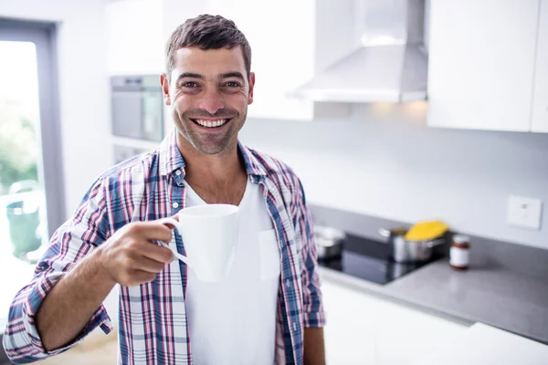 Portrait of happy man having coffee