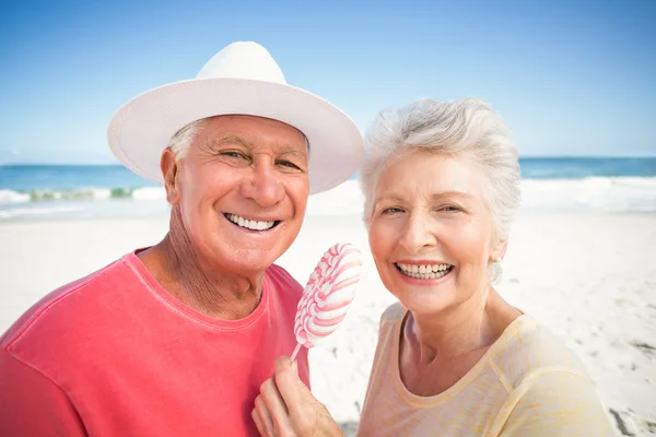 Senior couple eating lollipop