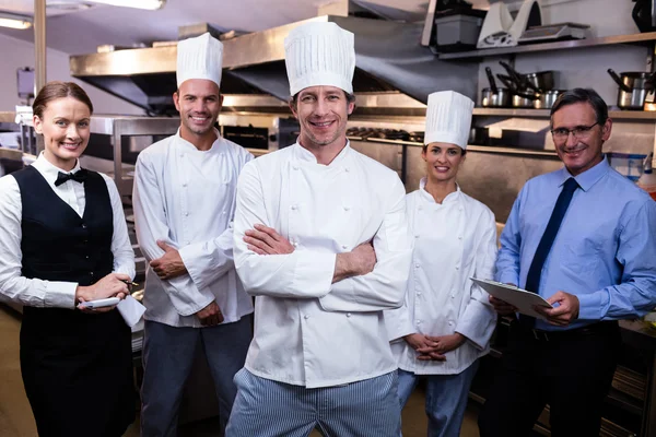 Restaurant team standing together in kitchen