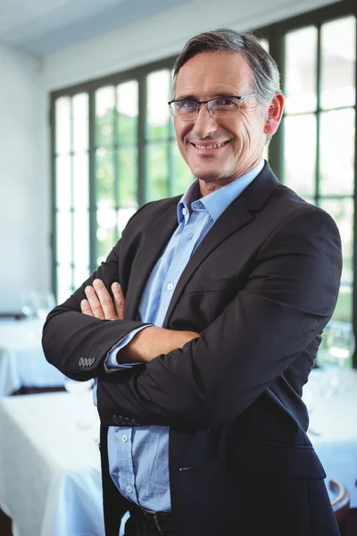 Smiling businessman posing with crossed arms