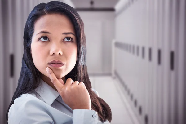 Thoughtful businesswoman with finger on chin