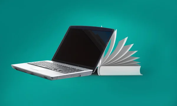 Laptop and book on green