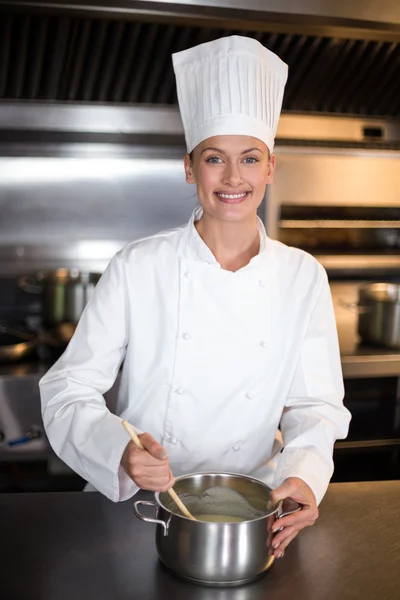 Female chef cooking in commercial kitchen