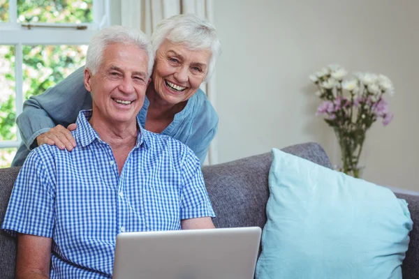 Retired couple using laptop