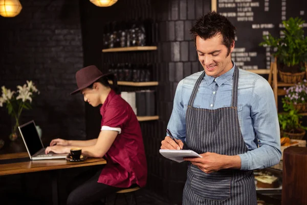 Waiter writing down the orders