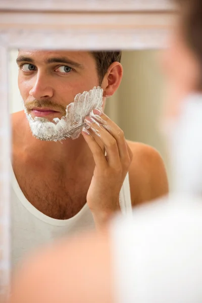 Man applying shaving foam