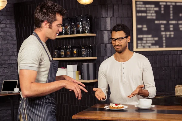 Waiter and customer having a discussion