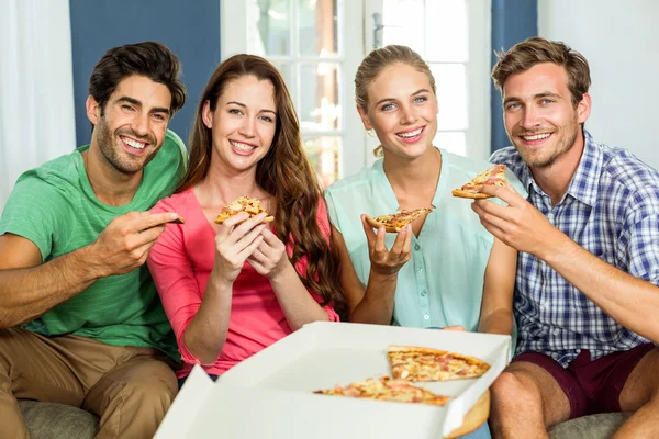 Happy friends eating pizza