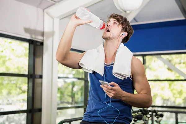 Man drinking water while exercising