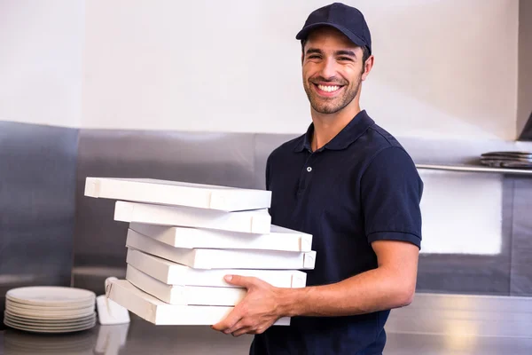 Pizza delivery man carrying boxes