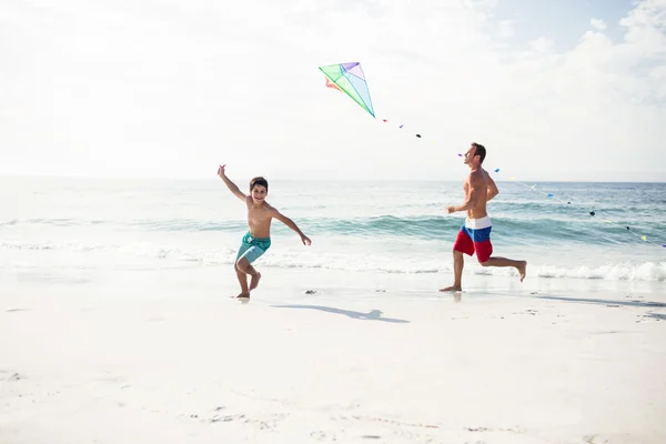 Father and son playing with kite