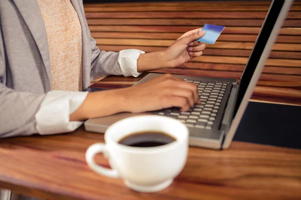 Woman using card to buy online