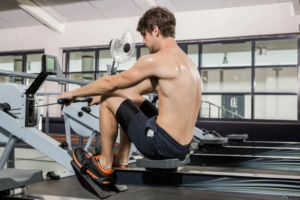 Man working out on rowing machine