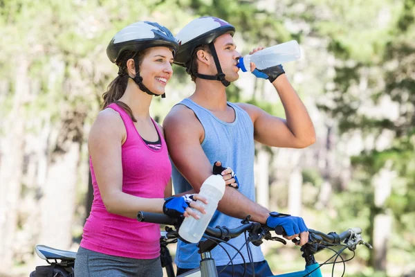 Young couple holding water bottles