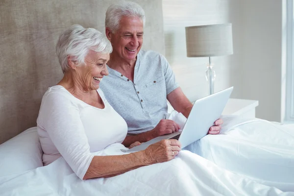 Retired couple using laptop