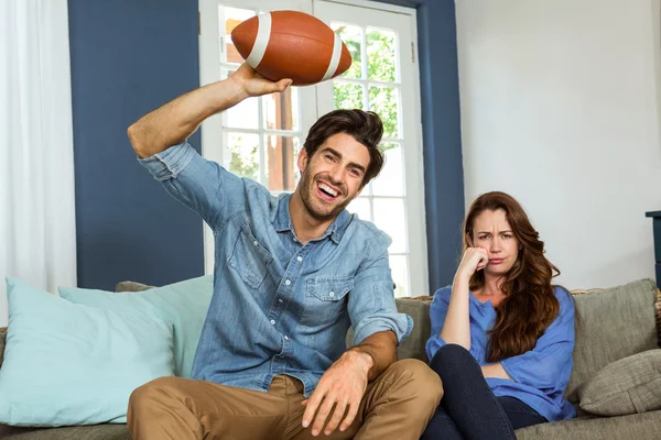 Couple watching american football match