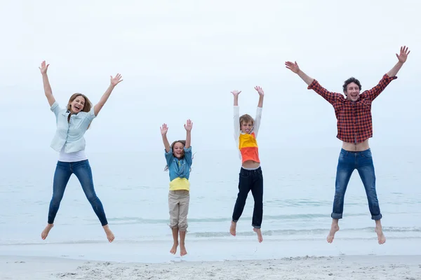 Family jumping with arms raised