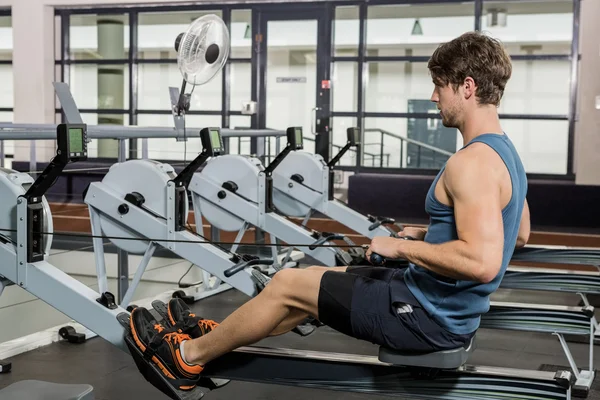 Man working out on rowing machine