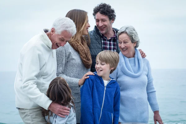 Family standing at beach