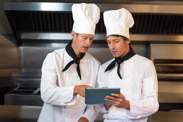 Chefs holding clipboard