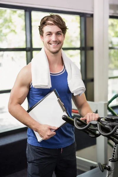 Gym instructor holding clipboard