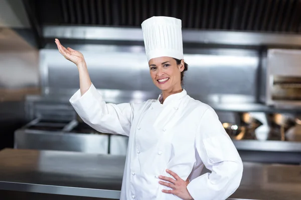 Chef gesturing in commercial kitchen