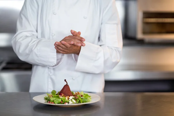 Chef and salad in commercial kitchen