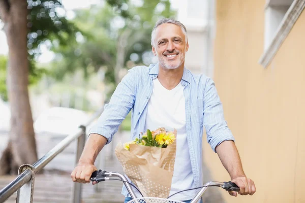 man with bicycle and bouquet