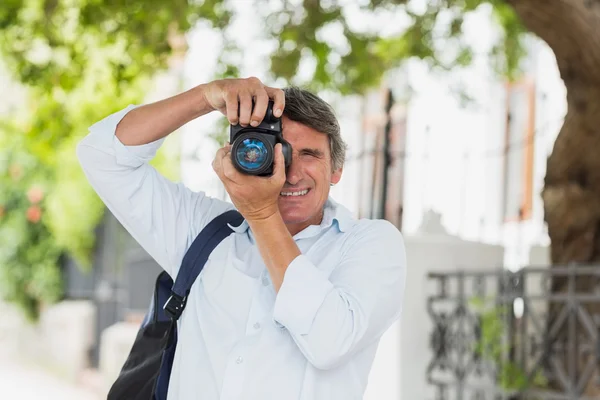 Man looking into camera in city