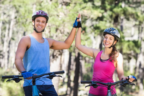 Young couple giving high five